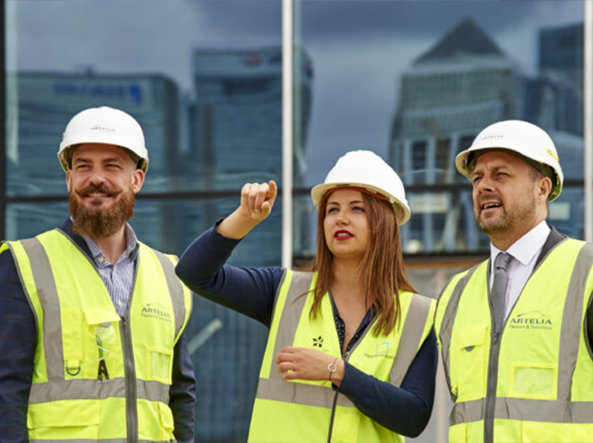Three Artelia employees in work clothes conducting a technical property inspection