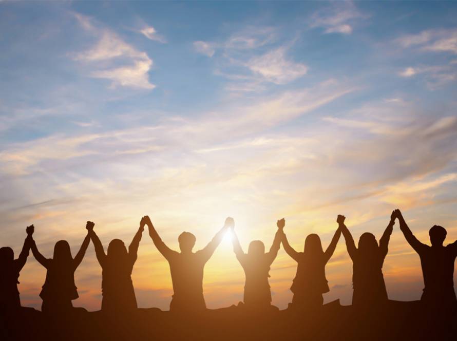 Group of people holding hands and raising their arms together