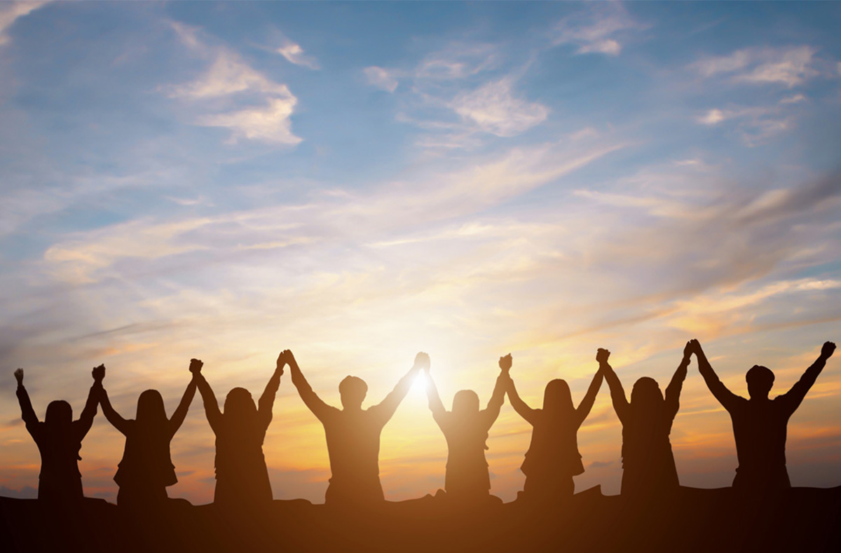 Group of people holding hands and raising their arms together