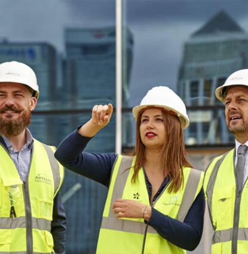 Three Artelia employees in work clothes conducting a technical property inspection